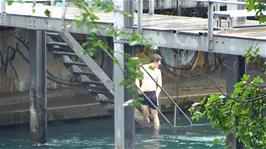 Ash makes it to the Public River Swimming Facility at Zurich - via the river, since the door is locked from the inside
